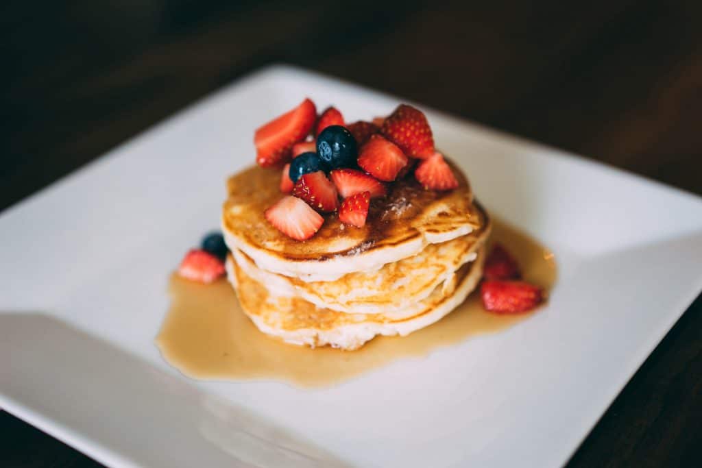 Assiette de pancakes avec sirop d'érable et fraises